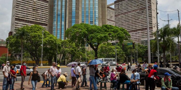 CARACAS (VENEZUELA), 05/06/2021.- Decenas de personas esperan afuera de un centro de vacunación contra la COVID-19, el 2 de junio de 2021 en Caracas (Venezuela). Cientos de venezolanos acudieron esta semana a los puntos de vacunación establecidos por el Gobierno, a la espera de ser vacunados. El sistema, que arrancó de forma "controlada", se convirtió, con el paso de los días, en desorden, en el que también influyó la suerte. EFE/ Miguel Gutiérrez