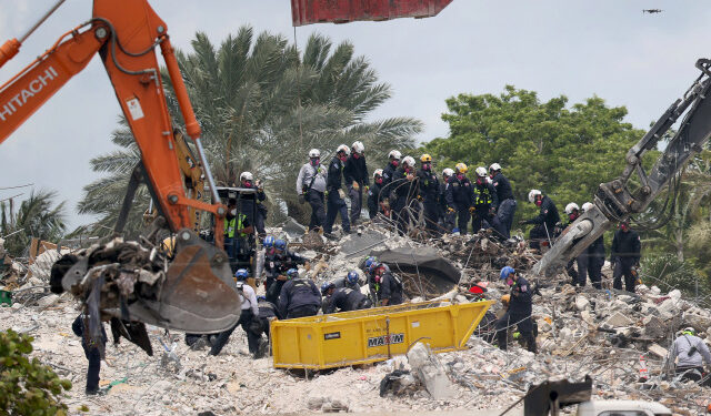 SURFSIDE, FLORIDA - JULY 05: After a brief stoppage to demolish the standing remains, Search and Rescue personnel continue working in the rubble pile of the partially collapsed 12-story Champlain Towers South condo on July 5, 2021 in Surfside, Florida. The decision by officials to bring the rest of the building down was brought on by the approach of Tropical Storm Elsa and fears that the structure might come down in an uncontrolled fashion. Over one hundred people are missing as the search-and-rescue effort continues.   Joe Raedle/Getty Images/AFP (Photo by JOE RAEDLE / GETTY IMAGES NORTH AMERICA / Getty Images via AFP)