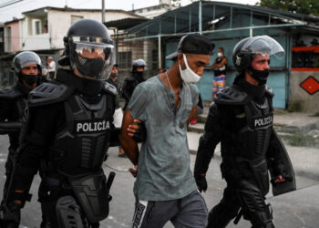 A man is arrested during a demonstration against the government of President Miguel Diaz-Canel in Arroyo Naranjo Municipality, Havana on July 12, 2021. - Cuba on Monday blamed a "policy of economic suffocation" of United States for unprecedented anti-government protests, as President Joe Biden backed calls to end "decades of repression" on the communist island. Thousands of Cubans participated in Sunday's demonstrations, chanting "Down with the dictatorship," as President Miguel Díaz-Canel urged supporters to confront the protesters. (Photo by YAMIL LAGE / AFP)