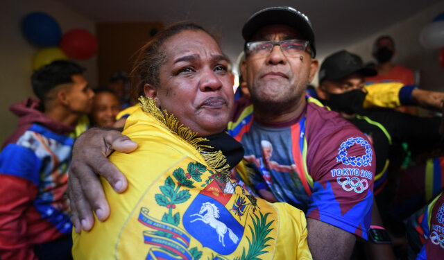 Venezuelan athlete Yulimar Rojas' mother, Yulecsi Rodriguez (L), reacts after watching her compete in the Tokyo Olympics 2020 at her home in Barcelona, Anzoategui state, Venezuela on August 1, 2021. - Venezuela's two-time world champion Yulimar Rojas set a new world record as she won Olympic gold in the women's triple jump on Sunday. (Photo by Federico PARRA / AFP)