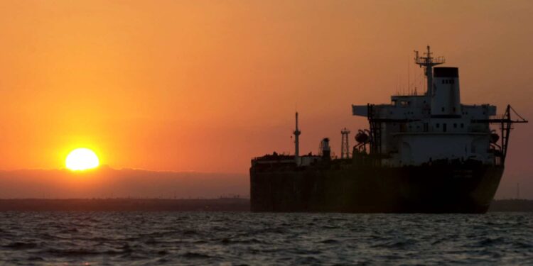 An oil tanker is silhouetted as the sun rises over Lake Maracaibo, Venezuela, on Friday, December 13, 2002.
