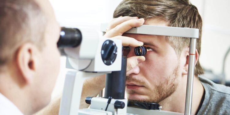 Ophthalmology concept. Male patient under eye vision examination in eyesight ophthalmological correction clinic