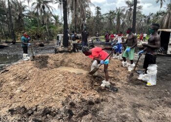 A person digs a grave for the mass burial of victims of the explosion at the illegal bunkering site in Imo state, Nigeria April 26, 2022. REUTERS/Tife Owolabi