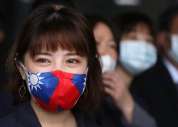 A staff wears a face mask with a Taiwanese flag design, as protection due to the coronavirus disease (COVID-19) outbreak, at a factory for non woven filter fabric used to make surgical face masks, in Taoyuan, Taiwan, March 30, 2020. REUTERS/Ann Wang