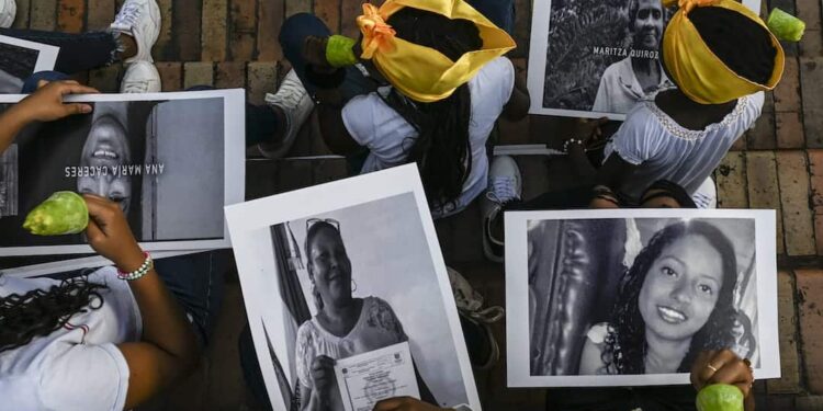 People take part in a demo against the murder of social leaders in Medellin, Colombia on July 26, 2019. (Photo by JOAQUIN SARMIENTO / AFP)