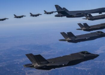 In this photo provided by South Korea Defense Ministry, a U.S. Air Force B-1B bomber, center, flies in formation with South Korea's Air Force F-35A fighter jets, bottom, and U.S. Air Force F-16 fighter jets, top, over the South Korea Peninsula during a joint air drill in South Korea, Sunday, Feb. 19, 2023. (South Korea Defense Ministry via AP)