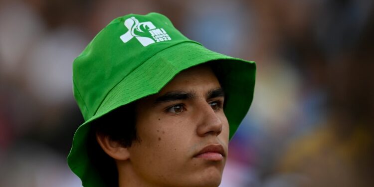 A pilgrim wearing a JMJ (WYD) hat attends the opening mass of the World Youth Day (WYD) gathering of young Catholics in Eduardo VII Park in Lisbon on August 1, 2023. Portugal is expecting about a million pilgrims from around the world, according to organisers, to attend the World Youth Day gathering of young Catholics from August 1 to 6. Originally scheduled for August 2022, the event was postponed because of the Covid-19 pandemic. (Photo by Patricia DE MELO MOREIRA / AFP)