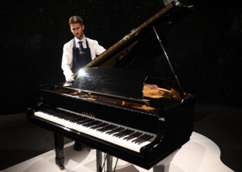 (FILES) Freddie Mercury's Yamaha G-2 baby grand piano, is pictured during a press preview ahead of the "Freddie Mercury: A World of His Own" auctions, at Sotheby's auctioneers in London on August 3, 2023. Thousands of items belonging to the charismatic Queen frontman Freddie Mercury, from manuscripts of his band's biggest hits to furniture, paintings and knick-knacks, go under the hammer in London. (Photo by Daniel LEAL / AFP)