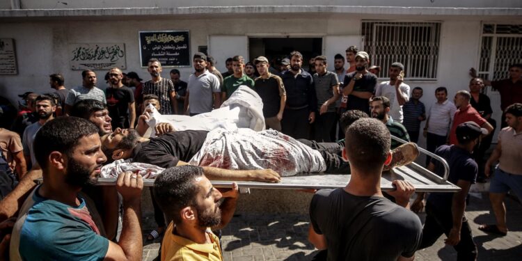 Northern Gaza Strip (---), 07/10/2023.- Palestinians carry the body of a fighter killed during the storming of Israel settlements by militants of the Ezz Al-Din Al Qassam militia, the military wing of Hamas movement, in Al-Shifa hospital in Gaza City, 07 October 2023. Rocket barrages were launched from the Gaza Strip early Saturday in a surprise attack claimed by the Islamist movement Hamas. In a televised statement, the Israeli prime minister said the country is at war. (tormenta) EFE/EPA/HAITHAM IMAD