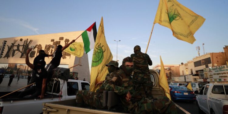 Members Iraq's Shiite Muslim al-Nujaba movement wave the Palestinian flag during a rally in Baghdad on October 8, 2023, to express their support of the "Operation Al-Aqsa Flood" which was launched by Hamas militants the previous day against Israel from the Gaza Strip. (Photo by Ahmad AL-RUBAYE / AFP)