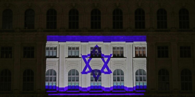 Bucharest (Romania), 09/10/2023.- The flag of the State of Israel is projected onto the facade of the Palace of the Romanian Parliament building, as a sign of solidarity, in Bucharest, Romania, 09 October 2023. More than 700 Israelis were killed and over 2,000 were injured since the Islamist movement Hamas carried out an unprecedented attack on southern Israel on 07 October, the Israeli army said. According to Palestinian officials, more than 700 people were killed and nearly 4,000 were injured as a result of Israel'Äôs retaliatory raids and air strikes in the Palestinian enclave. (Laos, Rumanía, Bucarest) EFE/EPA/Robert Ghement