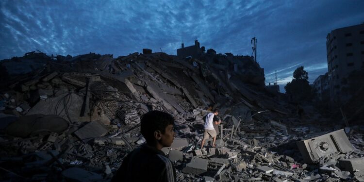 Gaza City (---), 07/10/2023.- Palestinians inspect the destroyed surrounding of the Palestine Tower after Israeli warplanes targeted it in Gaza City, 07 October 2023. Rocket barrages were launched from the Gaza Strip early 07 October in a surprise attack on Israel claimed by the Islamist movement Hamas. In a televised statement, the Israeli prime minister said the country is at war. EFE/EPA/MOHAMMED SABER