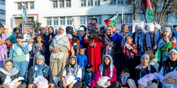 Moroccan women hold mock shrouded bodies of children and chant slogans during a protest in solidarity wih the Palestinian people in the Israeli occupied West bank and the Gaza Strip in Casablanca on November 18, 2023, amid continuing battles between Israel and the Palestinian militant group Hamas. (Photo by AFP)