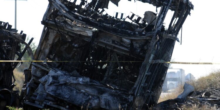 View of a burnt passenger bus after it crashed with a truck at the Mazatlan-Culiacan highwat in the community of La Cruz, Sinaloa state, Mexico on January 30, 2024. A crash between a passenger bus and a trailer left several dead and injured on Tuesday in the Mexican state of Sinaloa, authorities reported. (Photo by STRINGER / AFP)