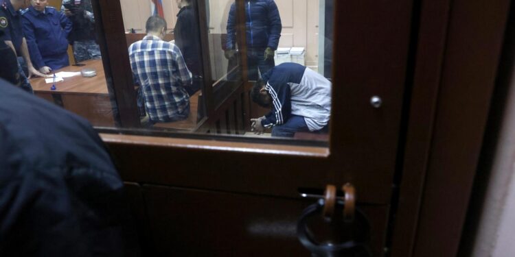 Moscow (Russian Federation), 24/03/2024.- A suspect in the shooting attack on the Crocus City Hall concert venue sits inside a defendant's enclosure during a hearing on pretrial restrictions at Basmanny district court, in Moscow, Russia, 24 March 2024. At least 137 people were killed and more than 180 hospitalized after a group of gunmen attacked the concert hall in the Moscow region on 22 March evening, Russian officials said. Eleven suspects, including all four gunmen directly involved in the terrorist attack, have been detained, according to Russian authorities. (Terrorista, Atentado terrorista, Rusia, Moscú) EFE/EPA/SERGEI ILNITSKY