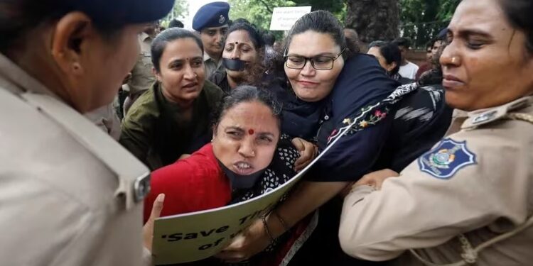 Police officers detain demonstrators during a protest against the alleged sexual assault of two tribal women in the eastern state of Manipur, in Ahmedabad, India, July 23, 2023. REUTERSAmit Dave.