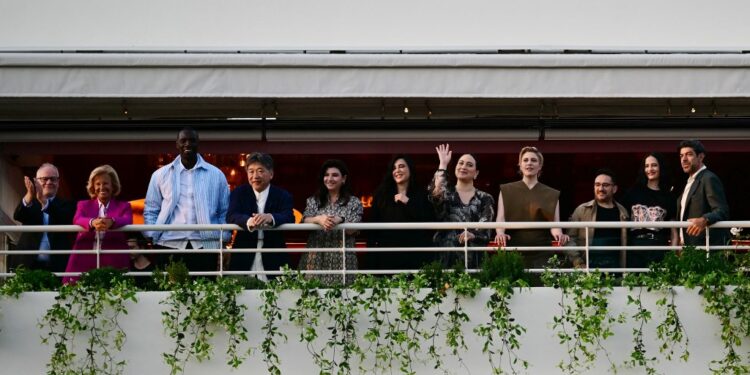 (From L) Cannes Film Festival director Thierry Fremaux, Festival President Iris Knobloch and members of the Jury the 77th edition of the Cannes Film Festival French actor and comedian Omar Sy, Japanese director Kore-eda Hirokazu, Turkish actress and screenwriter Ebru Ceylan, Lebanese director Nadine Labaki, US actress Lily Gladstone, US director and president of the Jury of the 77th Cannes Film Festival Greta Gerwig, Spanish director, producer, and writer Juan Antonio Bayona, French actress Eva Green and Italian actor Pierfrancesco Favino smile during a dinner of the jury at the Grand Hyatt Cannes Hotel Martinez, on the eve of the opening ceremony of the 77th edition of the Cannes Film Festival in Cannes, southern France, on May 13, 2024. (Photo by LOIC VENANCE / AFP)