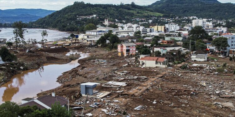 Aerial view showing houses destroyed by floods in Roca Sales, Rio Grande do Sul state, Brazil, on May 5, 2024. Authorities in southern Brazil scrambled Sunday to rescue people from raging floods and mudslides in what has become the region's largest ever climate catastrophe, with at least 78 dead and 115,000 forced from their homes. (Photo by Gustavo Ghisleni / AFP)