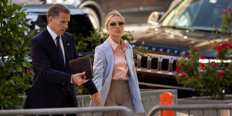 Hunter Biden (L), son of US President Joe Biden, joined by his wife Melissa Cohen Biden, arrives to the J. Caleb Boggs Federal Building on June 4, 2024 in Wilmington, Delaware. - Opening arguments are to be held on Tuesday in the trial of Hunter Biden on gun charges, the first ever prosecution of a child of a sitting US president. (Photo by RYAN COLLERD / AFP)