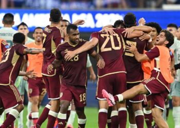 Venezuela's players celebrate after winning the Conmebol 2024 Copa America tournament group B football match against Mexico at SoFi Stadium in Inglewood, California on June 26, 2024. (Photo by Patrick T. Fallon / AFP)