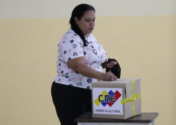 AME5564. CARACAS (VENEZUELA), 28/07/2024.- Una mujer vota este domingo, en un centro de votación en Caracas (Venezuela). Venezuela elegirá presidente en una jornada para la que están llamadas a las urnas más de 21 millones de personas. El Consejo Nacional Electoral (CNE) de Venezuela informó este domingo que, sobre las 08.00 hora local (12.00 GMT), el 95 % de los 15.797 centros de votación ya estaban abiertos -dos horas más tarde la hora oficial fijada para la apertura- y computando los votos de personas que acudieron desde muy temprano a las urnas. EFE/ Ronald Peña R.