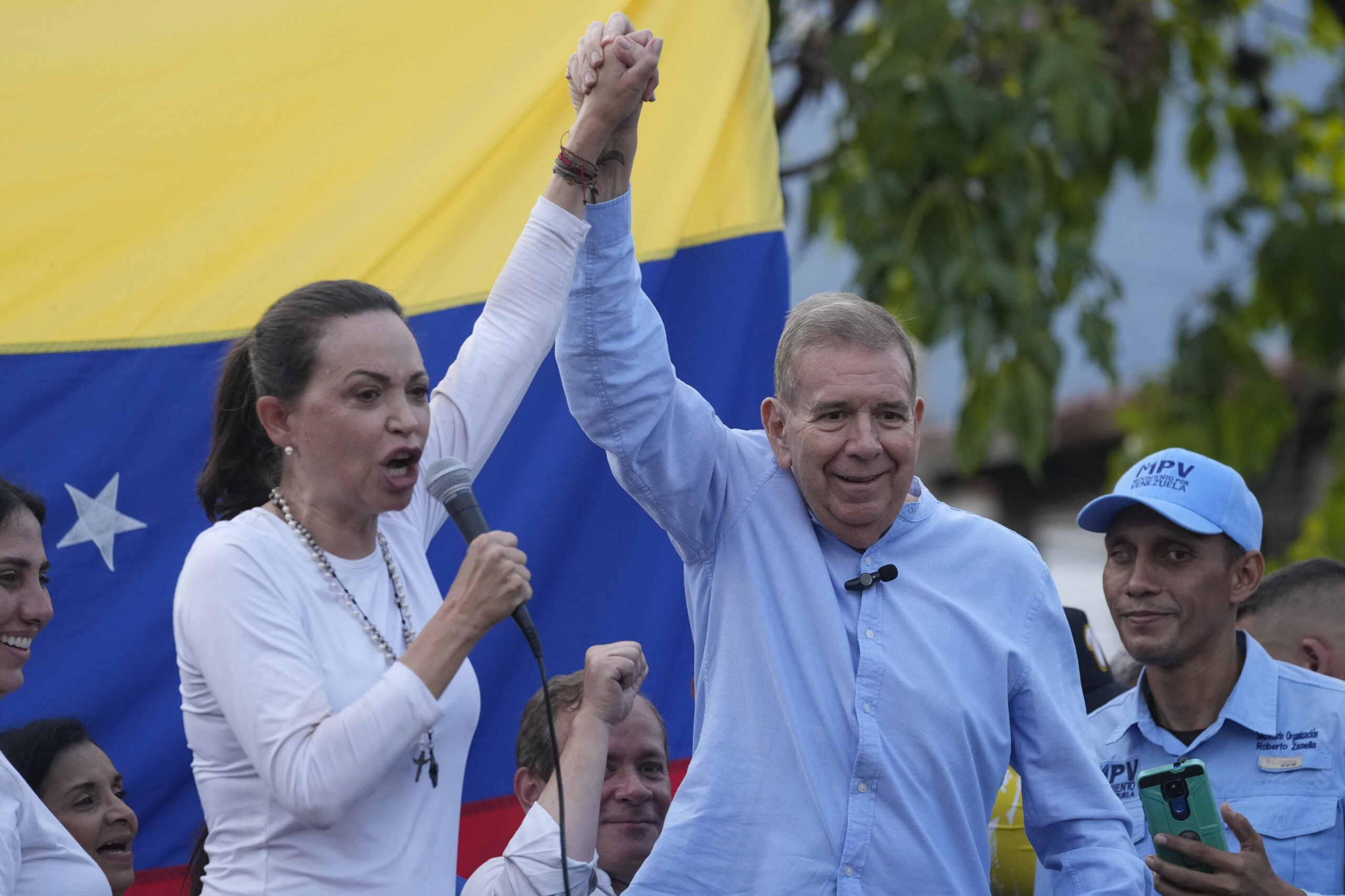 Venezuelan opposition leader Mariana Corina Machado and presidential candidate Edmundo González Urrutia,  raise their arms in unison during a rally in Guatire, Venezuela, Friday, May 31, 2024. (AP Photo/Ariana Cubillos)