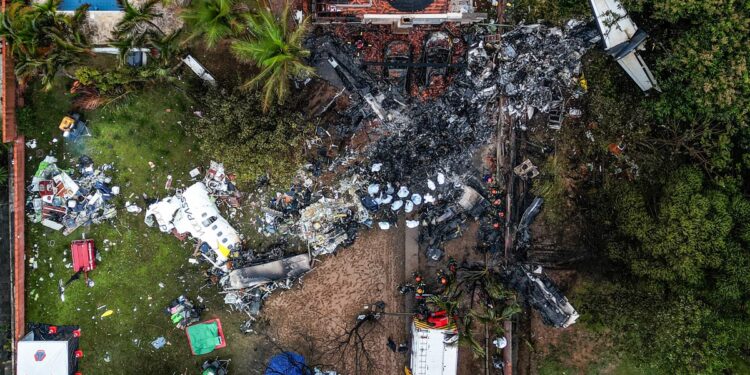 This photo shows an aerial view of the wreckage of an airplane that crashed with 61 people on board in Vinhedo, Sao Paulo State, Brazil, on August 10, 2024. - An airplane carrying 57 passengers and four crew crashed on August 9 in Brazil's Sao Paulo state, killing everyone on board, the airline said. The aircraft, an ATR 72-500 operated by Voepass airline, was traveling from Cascavel in southern Parana state to Sao Paulo's Guarulhos international airport when it crashed in the city of Vinhedo. (Photo by Nelson ALMEIDA / AFP)