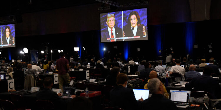 Journalists and members of the media watch from the spin room as US Vice President and Democratic presidential candidate Kamala Harris and former US President and Republican presidential candidate Donald Trump participate in a presidential debate at the National Constitution Center in Philadelphia, Pennsylvania, on September 10, 2024. (Photo by MATTHEW HATCHER / AFP) (Photo by MATTHEW HATCHER/AFP via Getty Images)