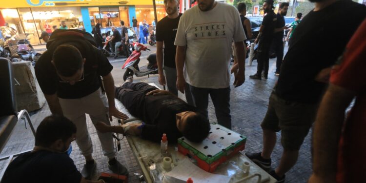 A man donates blood under a tent in Beirut's southern suburb on September 17, 2024, after explosions hit locations in several Hezbollah strongholds around Lebanon amid ongoing cross-border tensions between Israel and Hezbollah fighters. - Hundreds of pagers used by Hezbollah members exploded across Lebanon Tuesday, killing at least eight people and wounding Tehran's ambassador in Beirut in blasts the Iran-backed militant group blamed on Israel. (Photo by AFP)