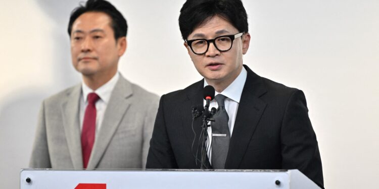 South Korea's ruling People Power Partys leader Han Dong-hoon (R) speaks during a press conference on the parliamentary election at the party's headquarters in Seoul on April 11, 2024. The leader of South Korea's ruling party resigned on April 11 after the party was trounced by the opposition in parliamentary elections, leaving President Yoon Suk Yeol a lame duck for the remainder of his term. (Photo by Jung Yeon-je / AFP)