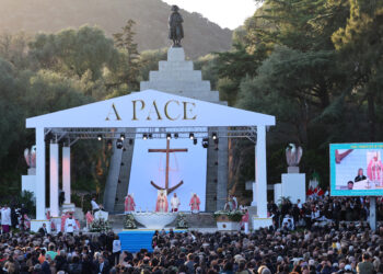 Pope Francis (C) presides over a mass at Place dAusterlitz (U Casone) with a commemorative monument statue of Napoleon the 1st in the background in Ajaccio, as part of his trip on the French island of Corsica, on December 15, 2024. - Pope Francis visits Corsica, a stronghold of the Catholic faith with locals hotly anticipating the first-ever trip by a pontiff to the French Mediterranean island. His short trip, based around a congress on faith in the Mediterranean region, comes just a week after he snubbed the re-opening of Notre Dame cathedral in Paris five years after a devastating fire. (Photo by Pascal POCHARD-CASABIANCA / AFP)