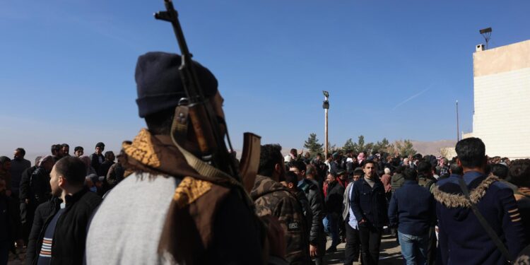 Damascus (Syrian Arab Republic), 09/12/2024.- An armed rebel stands guard as Syrians search for relatives they believe were held in secret cells at Sednaya prison, dubbed by Amnesty International as the 'Human Slaughterhouse', near Damascus, Syria, 09 December 2024. The Political Affairs Department of the Syrian Salvation Government said 30,000 prisoners have been released so far from only the first floor of Sednaya prison in Damascus. Rescue efforts continue to find prisoners. Syrian rebels entered Damascus on 08 December 2024 and announced in a televised statement the 'Liberation of the city of Damascus and the overthrow of Bashar al-Assad', as well as the release of all the prisoners. (Siria, Damasco) EFE/EPA/MOHAMMED AL RIFAI