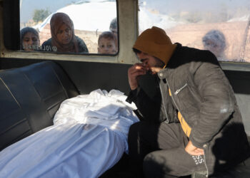 EDITORS NOTE: Graphic content / A Palestinian man mourns a relative, killed in an Israeli strike the previous night, as he sits in the back of an ambulance ahead of the funeral outside the Al-Ahli Arab hospital, also known as the Baptist hospital, in Gaza City on January 1, 2025, as the war between Israel and Hamas militants continues. (Photo by Omar AL-QATTAA / AFP)