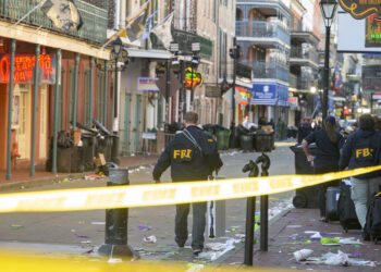 FBI investigators arrive at the scene where the white Ford F-150 pickup truck that crashed into a work lift after allegedly driving into a crowd of New Year's revelers in the French Quarter of New Orleans, Louisiana, on January 1, 2025. - At least 10 people were killed and 30 injured Wednesday when a vehicle plowed overnight into a New year's crowd in the heart of the thriving New Orleans tourist district, authorities in the southern US city said. (Photo by Matthew HINTON / AFP)