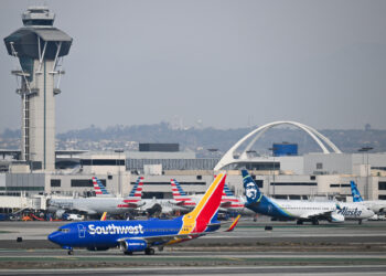 A Southwest Airlines Boeing 737-700 airplane taxis past American Airlines and Alaska Airlines airplanes at Los Angeles International Airport (LAX) in Los Angeles, California on January 31, 2025. (Photo by Patrick T. Fallon / AFP)