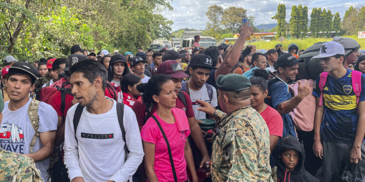 Migrants talk to Panamanian National Border Service members as they try to cross the border between Panama and Costa Rica while trying to return to Venezuela, at Paso Canoas between Panama and Costa Rica border on February 11, 2025. Dozens of Venezuelan migrants crossed the border from Costa Rica into Panama on Tuesday in a small caravan as they gave up the journey to the United States, overwhelmed by the grueling journey and fearful of Donald Trump's harsh anti-immigrant policies. (Photo by PAUL MONTENEGRO / AFP)