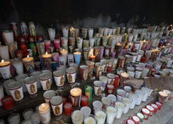 Candles left by faithfuls are pictured after a mass for the health of Pope Francis at the Basilica de Guadalupe in Mexico City on February 23, 2025. Pope Francis's condition "remains critical", the Vatican said Sunday on his 10th day in hospital as Catholics around the world prayed for the 88-year-old's recovery. (Photo by Alfredo ESTRELLA / AFP)